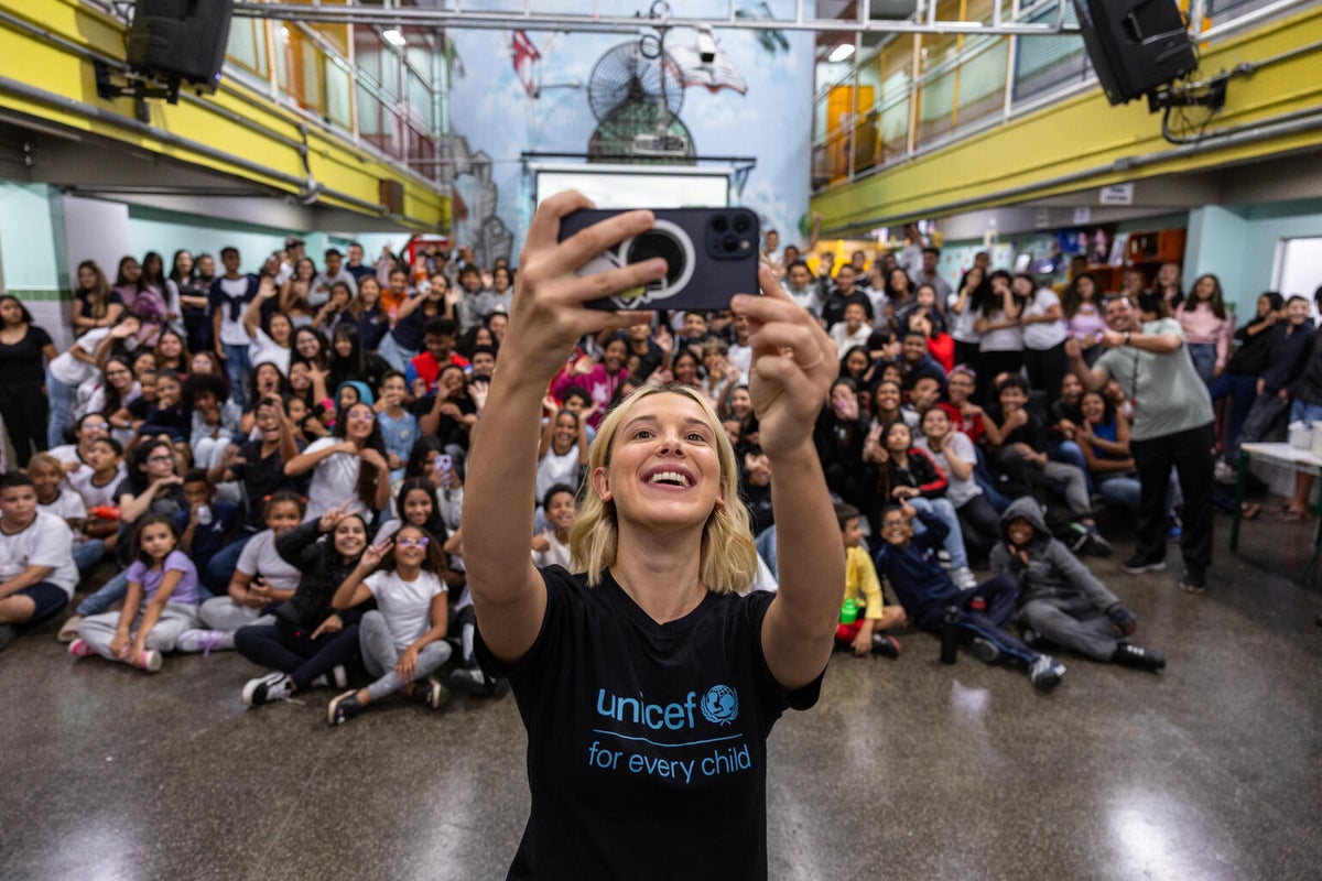 Millie Bobby Brown takes a selfie with the students at a school in Brazil, which is located in a community where UNICEF supports vulnerable children and their families. 