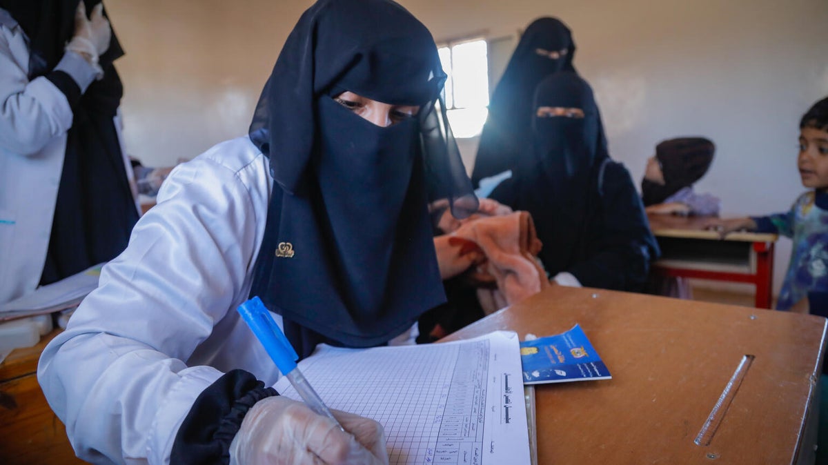 Female doctors record data of children receiving treatment at the UNICEF-supported mobile clinic. 