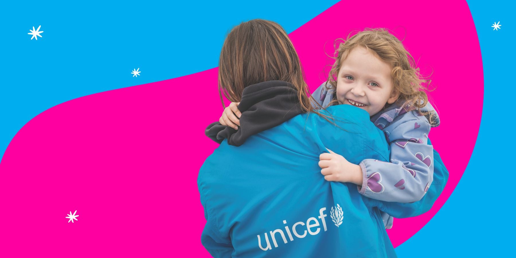 A young child from Romania being helped by a UNICEF worker.
