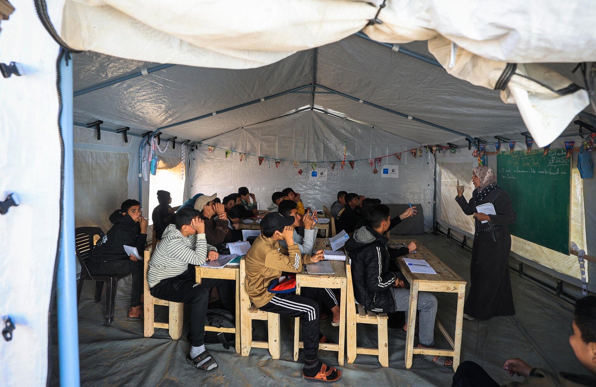 Children learning in a temporary tent.