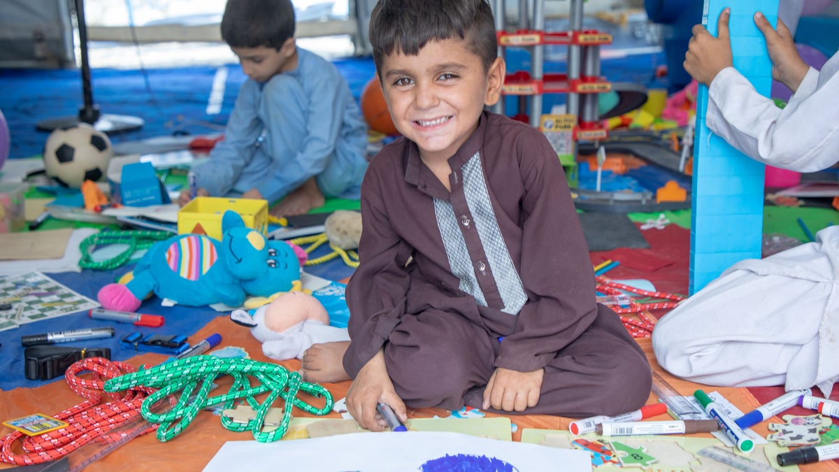 A young boy plays inside a UNICEF-supported child-friendly space in Afghanistan, where children receive psychosocial services and participate in wellbeing activities.