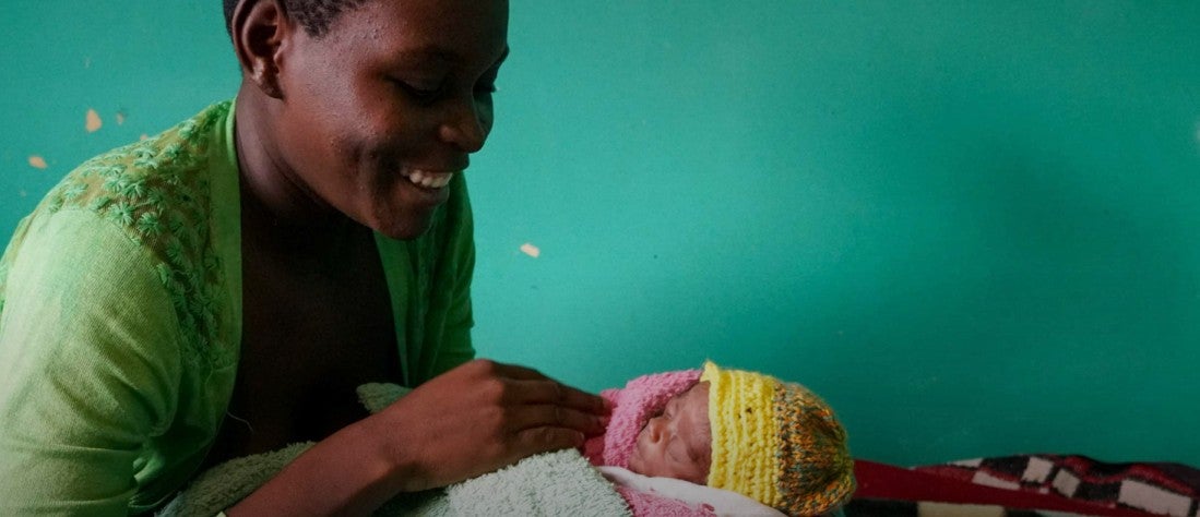 Mother looks on at newborn child