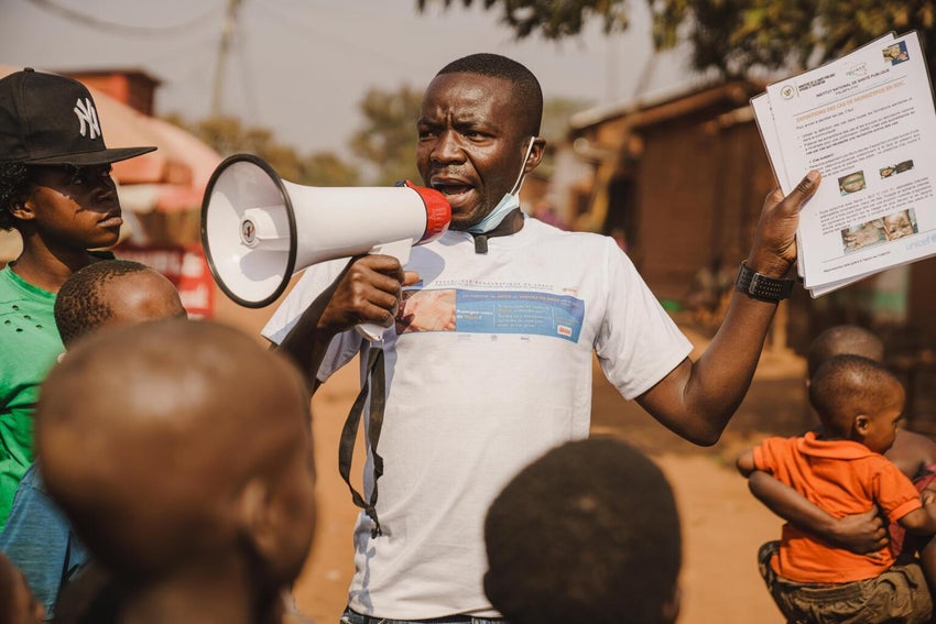 A UNICEF-supported community outreach worker uses his megaphone to raise community awareness about mpox in the DRC. 