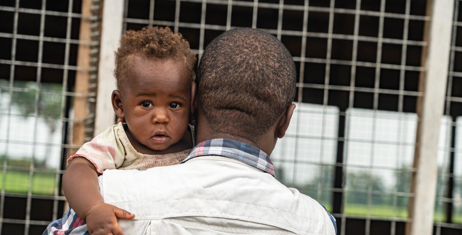 A UNICEF worker helps a child in the DRC.