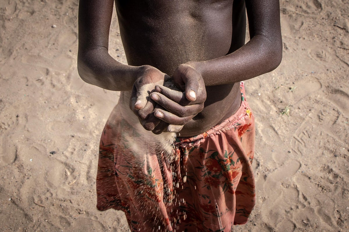 Sand flows through a child's hands in Ethiopia.  