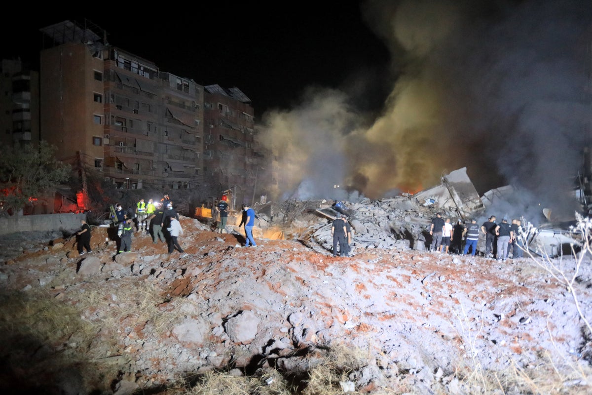 Rescuers searching for survivors after airstrikes reduced six buildings to rubble in Beirut on 27 of September 
