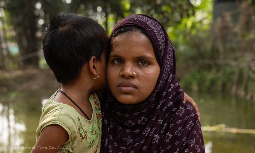 Sufiya and her daughter at a pond behind their house.