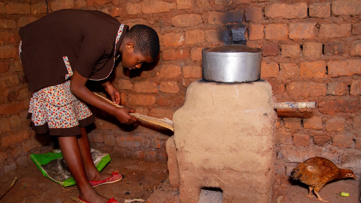 Student uses her newly built rocket stove in her home. 