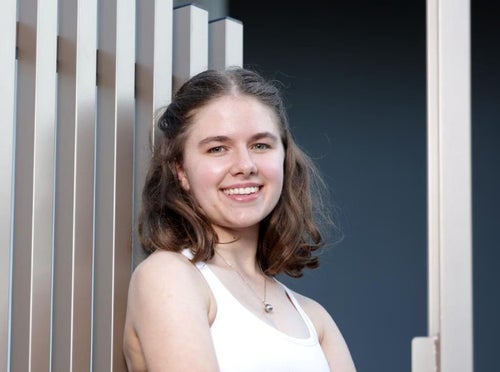 Young teenaged girl smiles to the camera