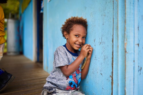 A young boy poses for a photo outside a health centre in a remote village in Papua New Guinea.