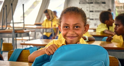 A UNICEF Staff member with a little girl in Kiribati during a routine vaccination program.