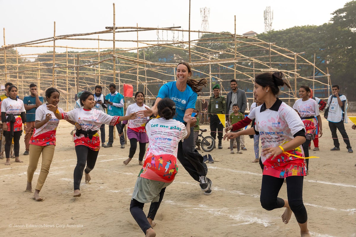 Emma plays with young girls in Korail, Dhaka.   