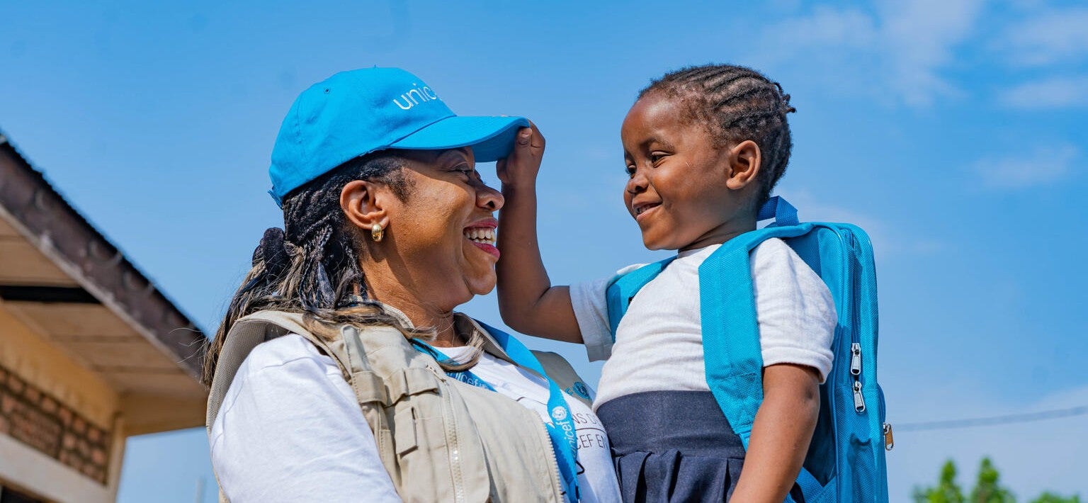 A UNICEF worker with a child