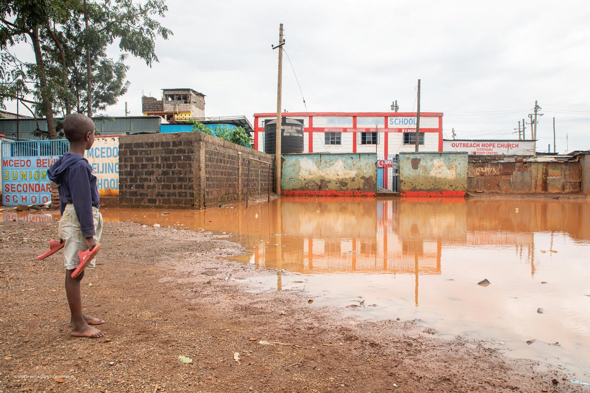 A young boy gazes at his school, which has been submerged by floodwaters in Nairobi, Kenya.