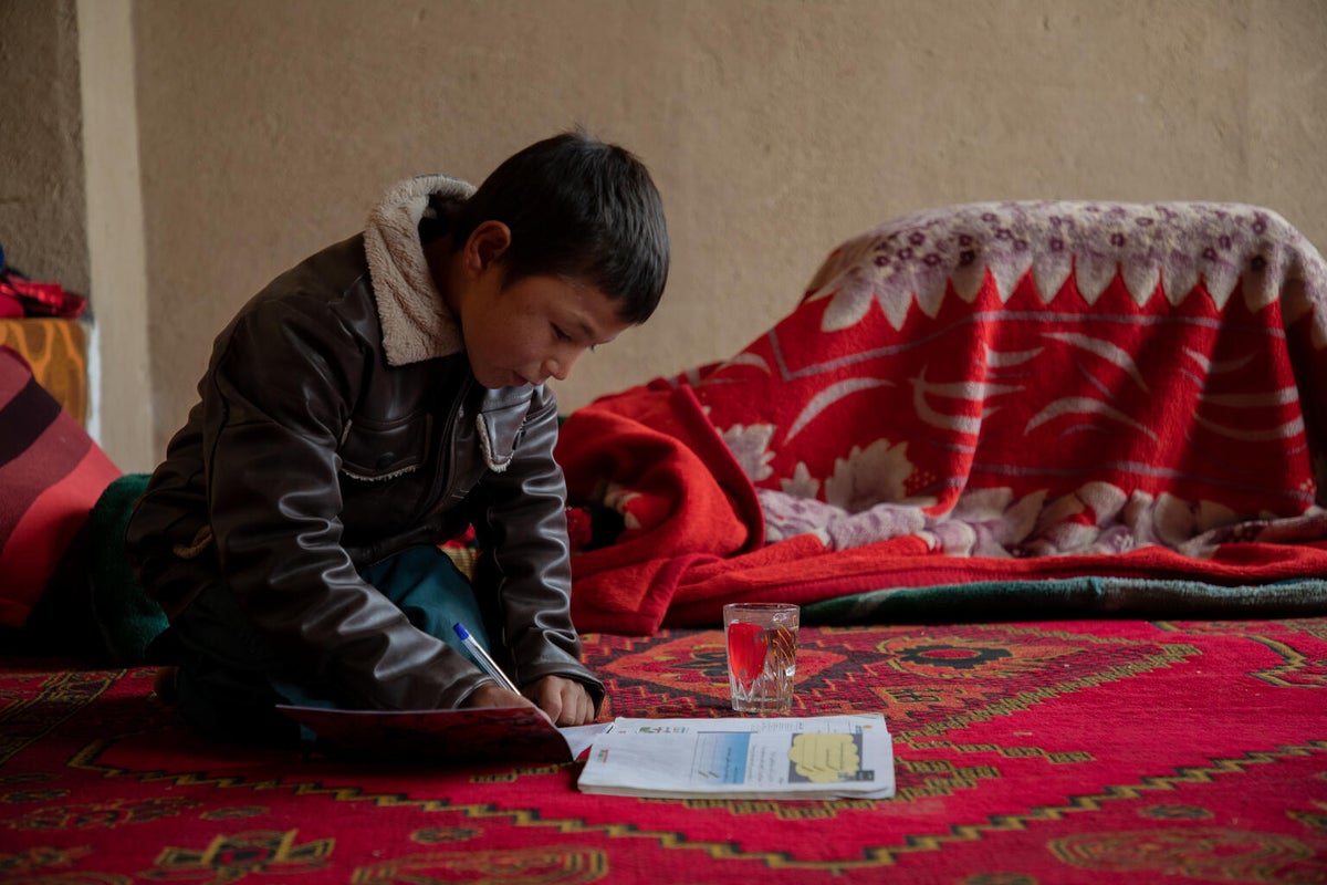 A young boy reading a book. 