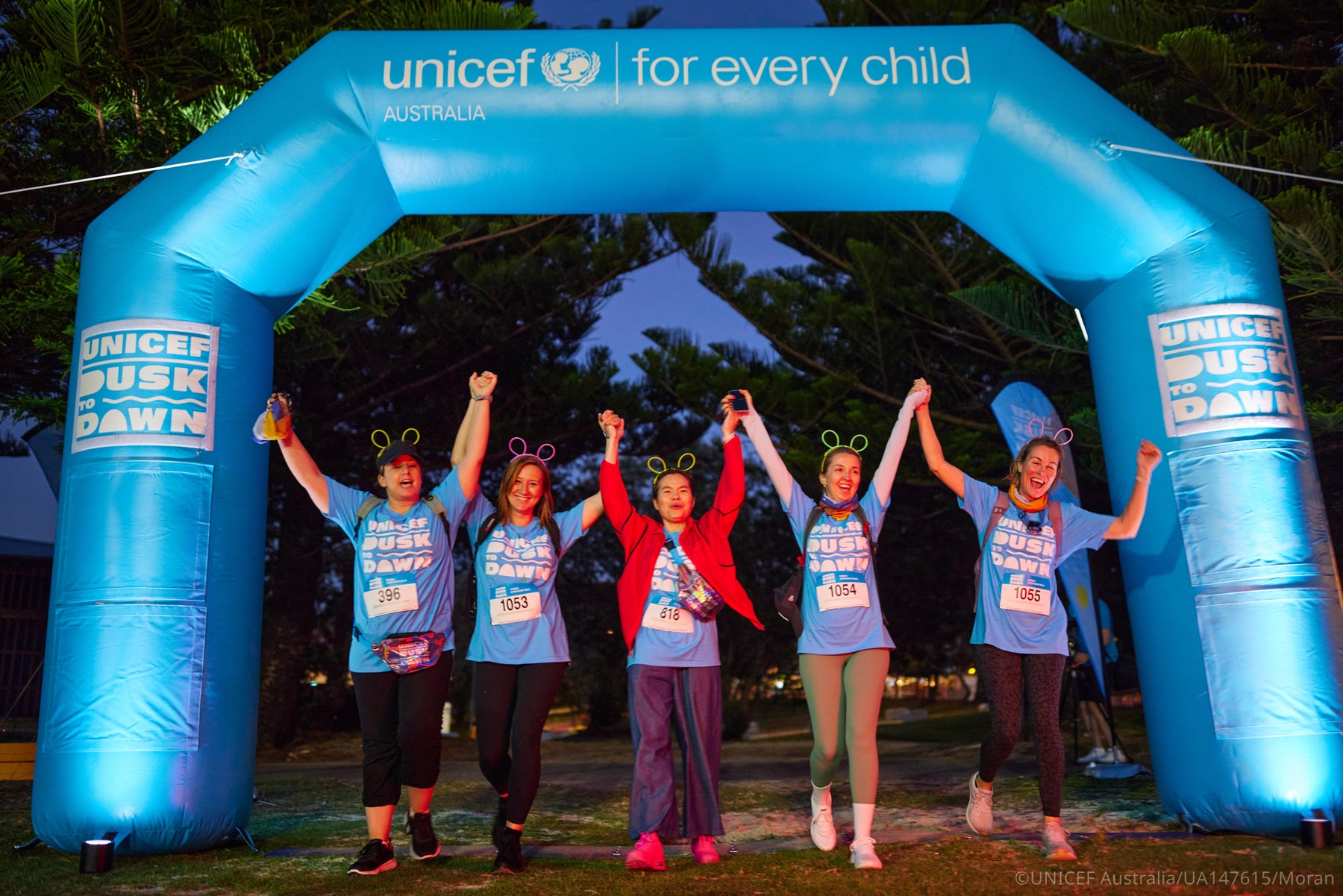 Group of walkers crossing the finishing line