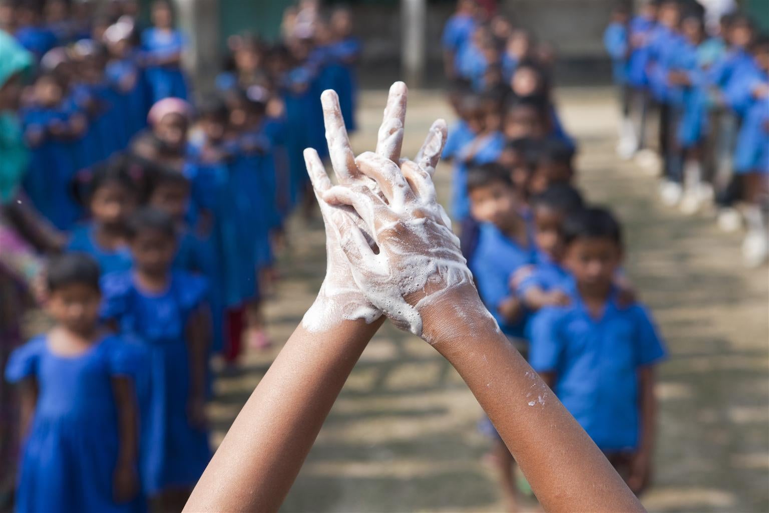 A pair of hands covered in foamy soap.