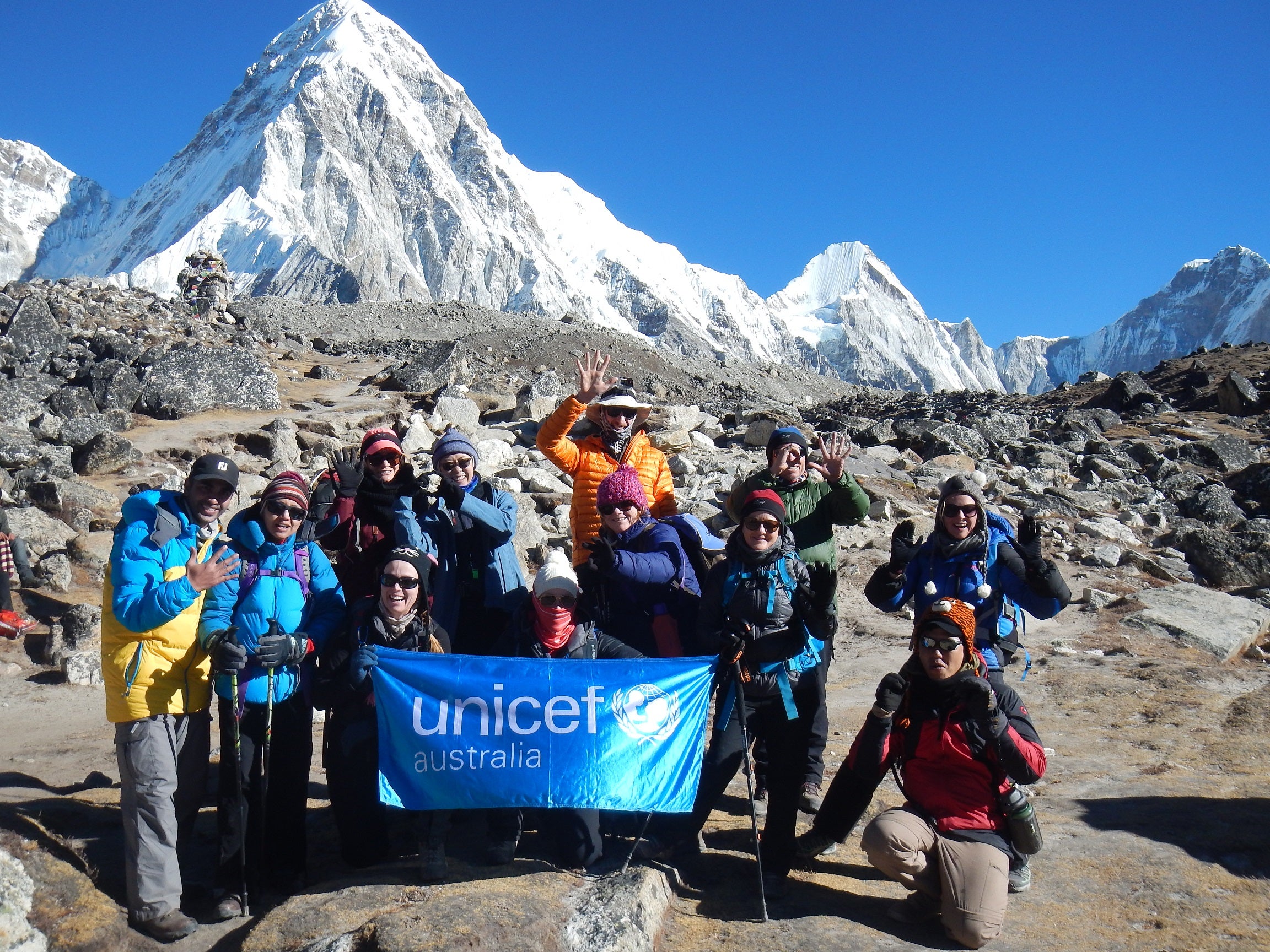 A group of alpinists with Mt. Everest behind them