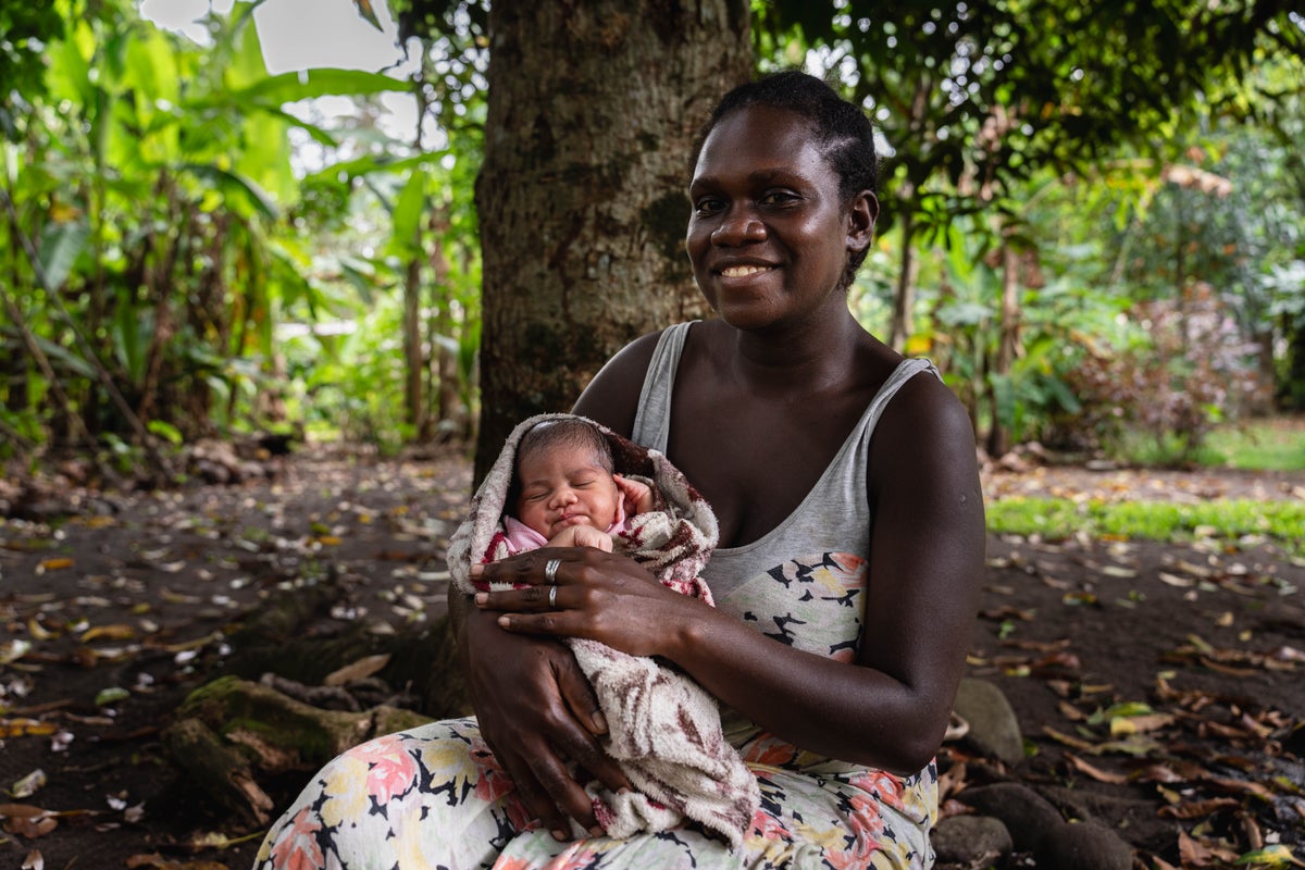A mother holding her newborn baby.