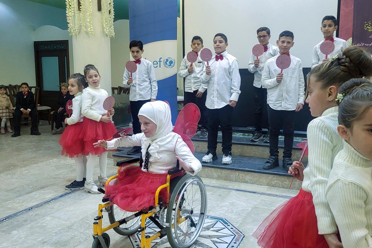A young girl performing in front of her peers. 