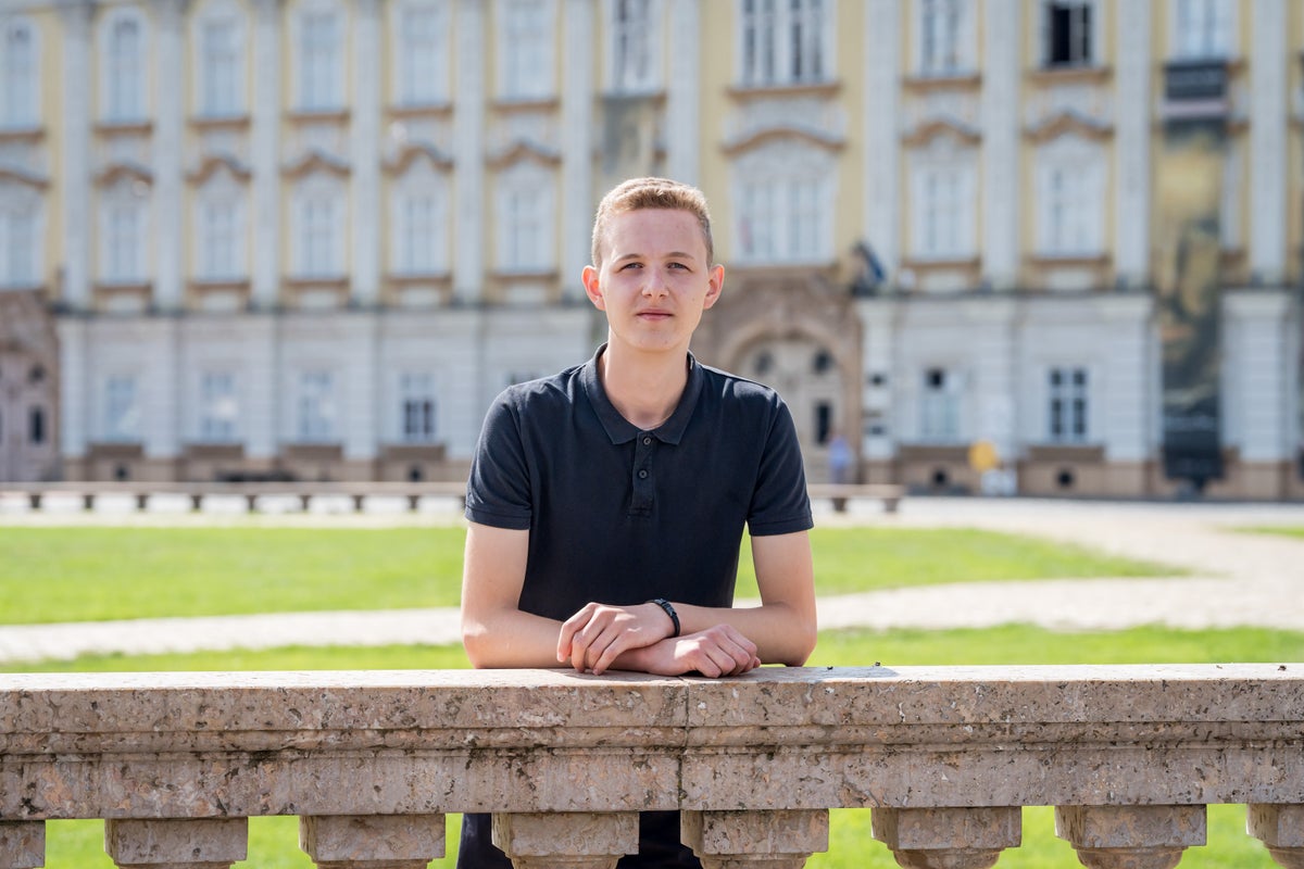 18-year-old Denys, a Ukrainian refugee, poses in a location in Romania, where he now lives. 