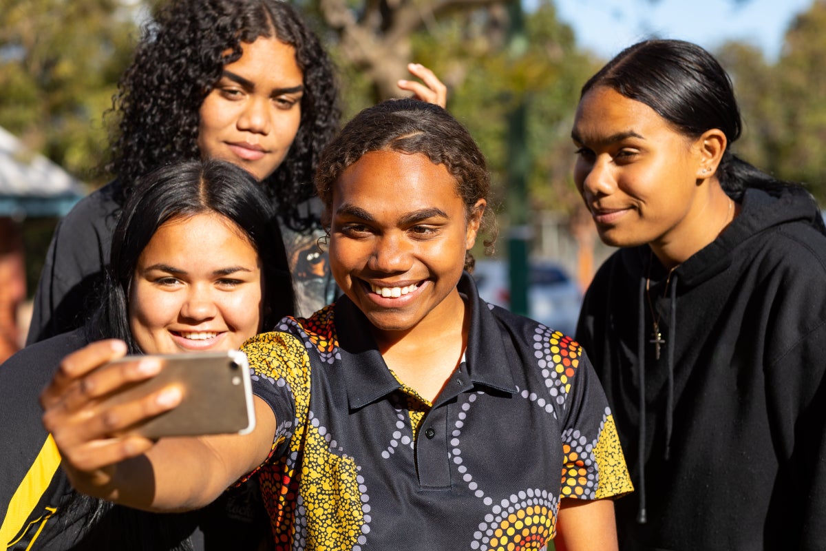 A group of First Nations teens take a selfie.