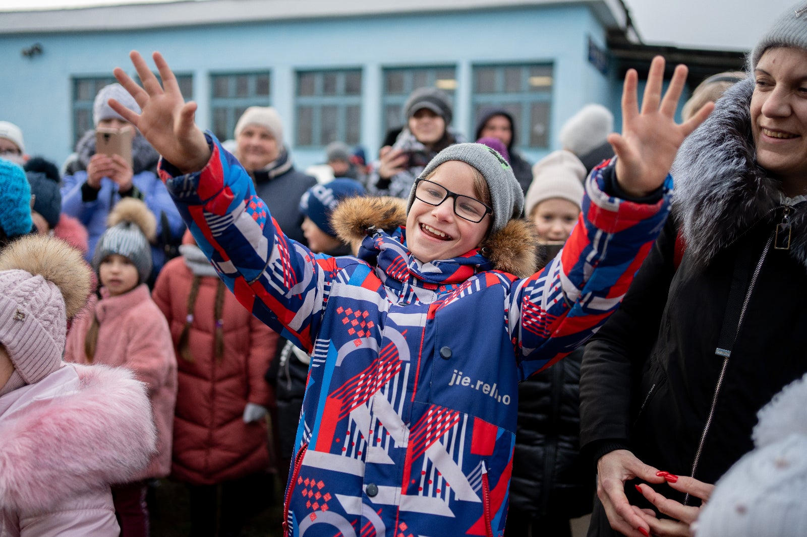 A child is excited to receive UNICEF supplies during a holiday season celebration at the Kherson Railway Station, Ukraine.