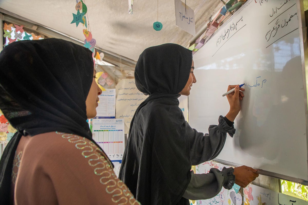 A young girl learns at a UNICEF-supported school
