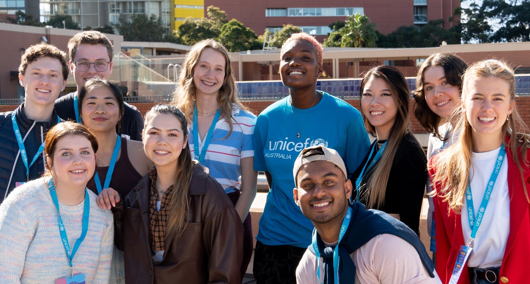 Arlo Parks with a group of young people. She is wearing a UNICEF T-shirt