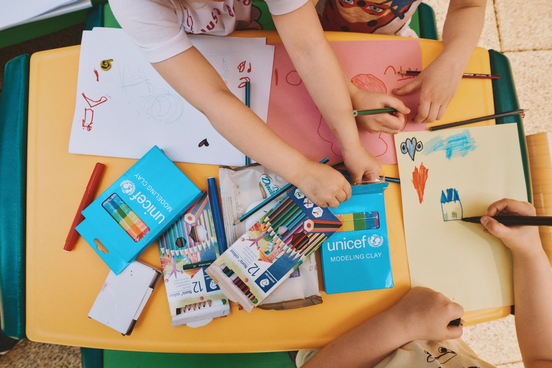 Children drawing on a table.