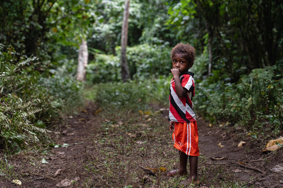 A young boy sucking on his thumb. 