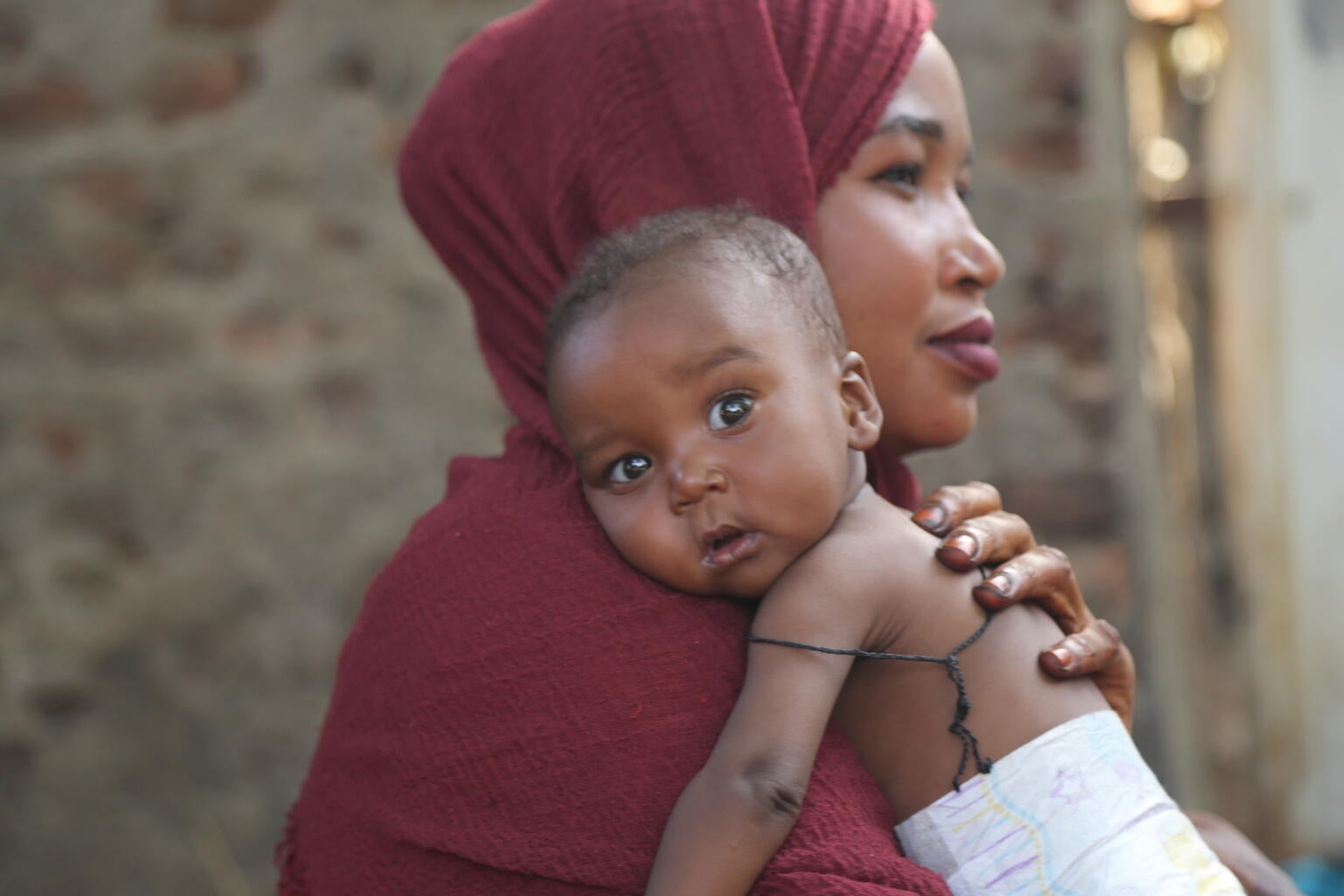 A child being held by their mother in Sudan.