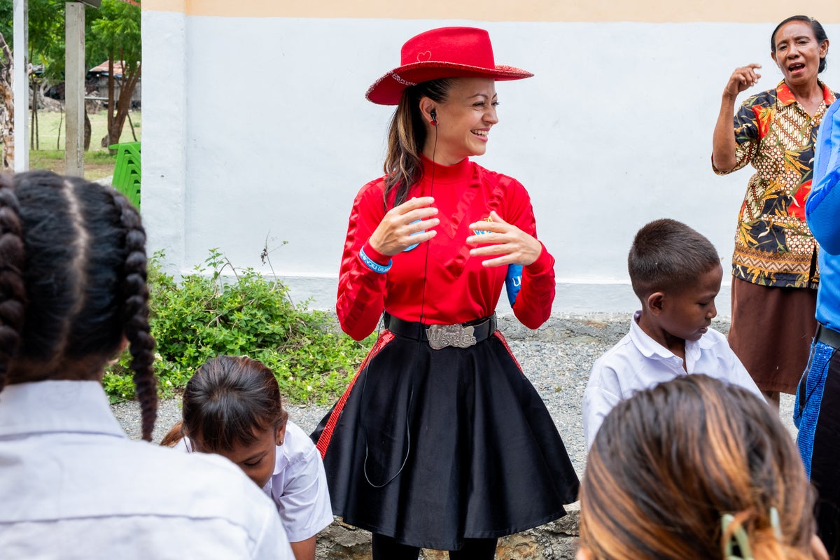 A woman shaking her hands dry.