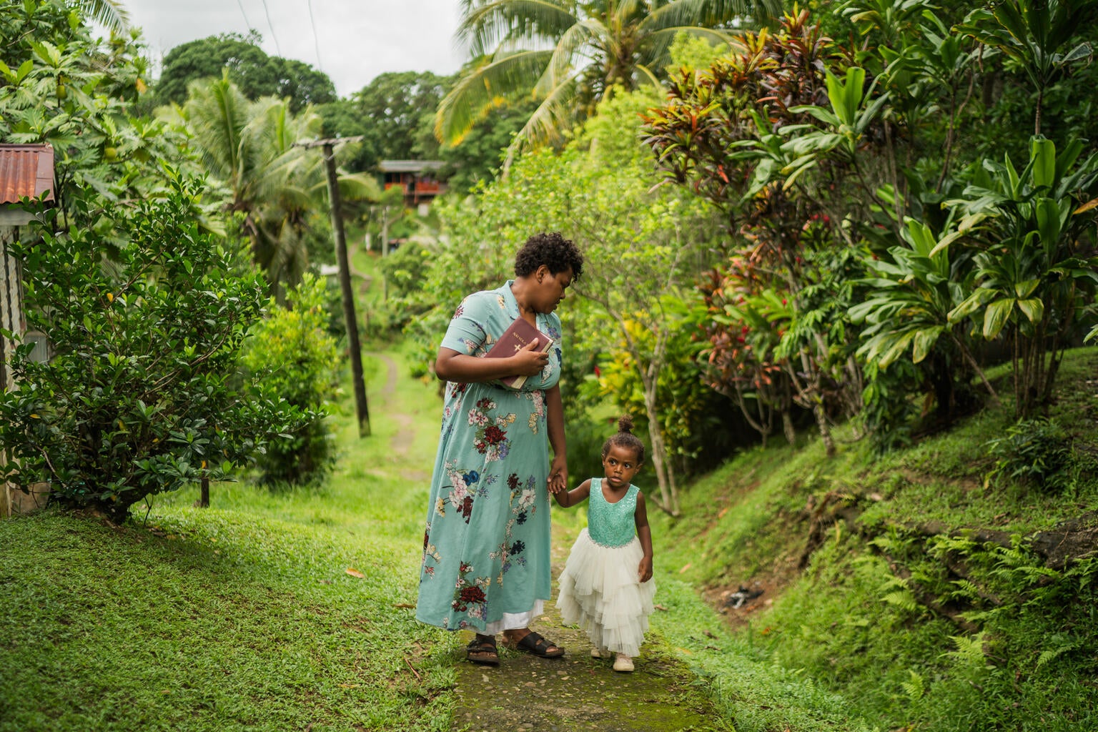 A mother walking with her child in Fiji