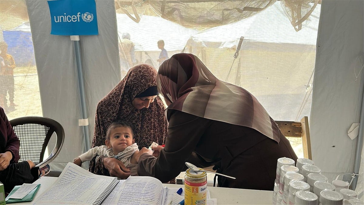 At a UNICEF-supported nutrition clinic in Khan Yunis, a child is being screened for malnutrition.