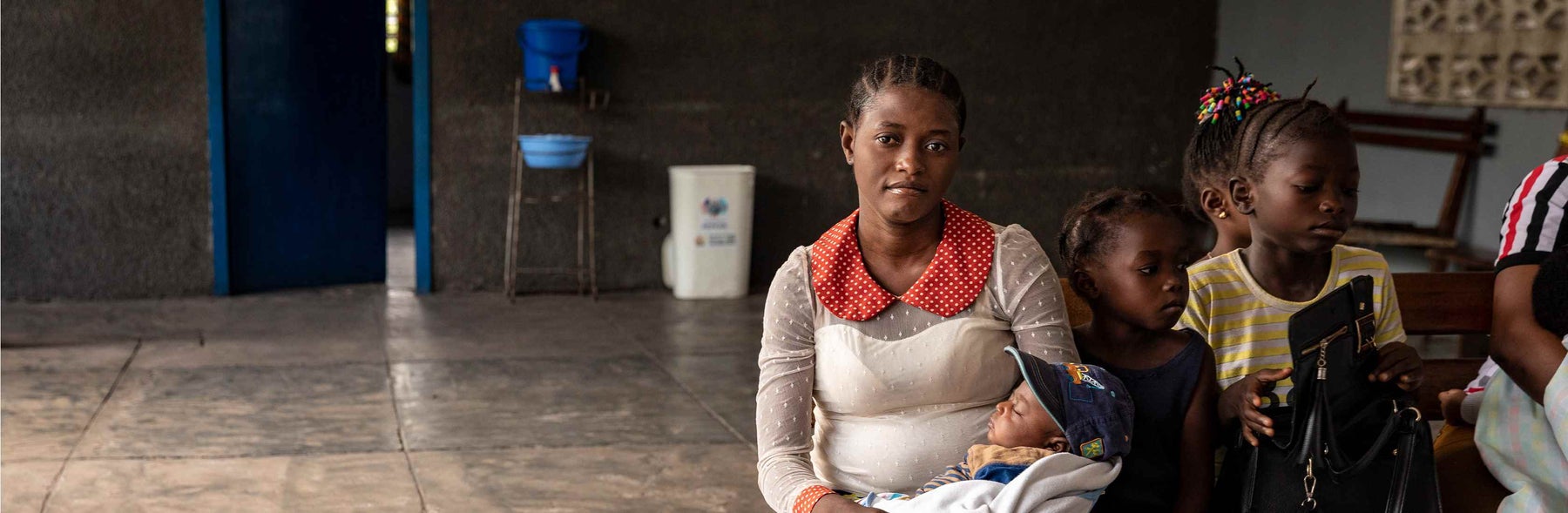 Mama Bwanga holds her child 