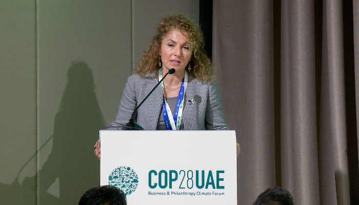 Anousheh Ansari behind a podium at COP28