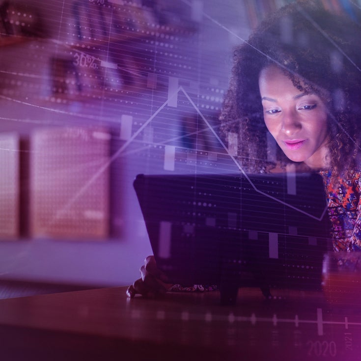 A woman looks at a computer screen