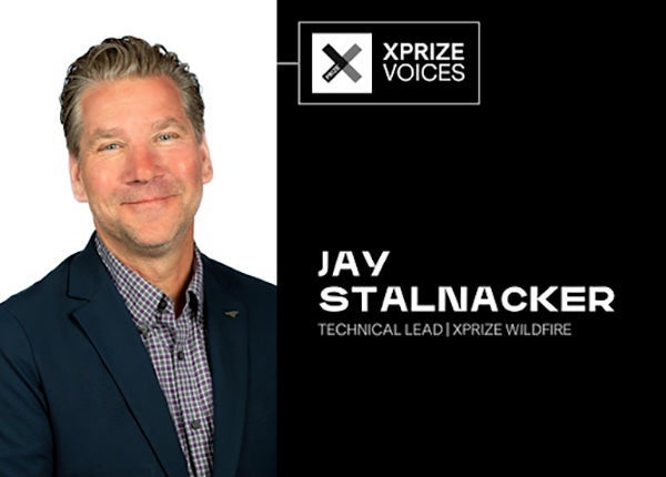 Jay Stalnacker sits in front of a white backdrop. His name and title are on the right side of the image.