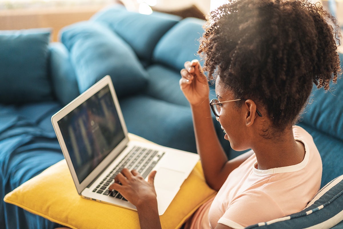 A young girl learning on a laptop