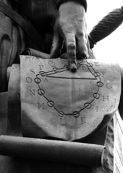 Wreath of spheres, detail of statue of Simon Stevin, Bruges, Belgium (Wikimedia commons)