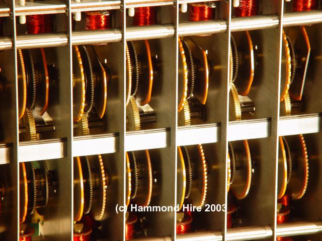 An actual array of 6 tone wheel bays in a Hammond organ; the pickups wrapped in red wire are visible at top and bottom (Hammond Hire)
