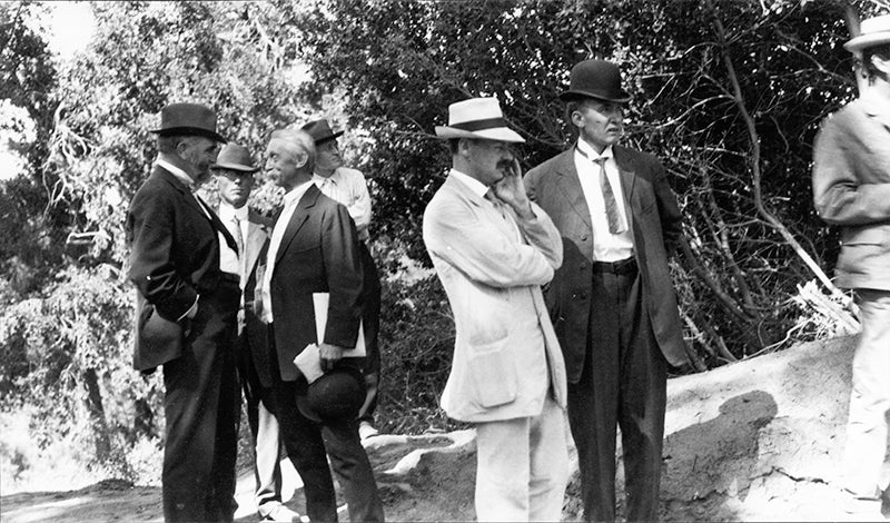 Group portrait, Karl Schwarzschild in the white suit talking to Vesto Slipher, with Jacobus Kapetyn in foreground, second from left, photograph taken in 1910 at Mount Wilson Observatory, Emilio Segrè Visual Archives, American Institute of Physics (repository.aip.org)