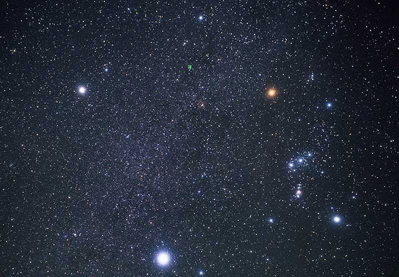 The bright stars Procyon (top left), Betelgeuse (top right), and Sirius (bottom center), photograph (Wikimedia commons)
