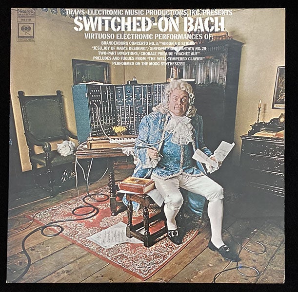 First issue cover for LP album, Switched-on Bach, with Walter/Wendy Carlos playing the Moog modular synthesizer, Columbia Records, 1968.  This cover was soon replaced with another where Bach is standing, the headphones have been taken off, and Carlos’s name has been added (author’s collection)