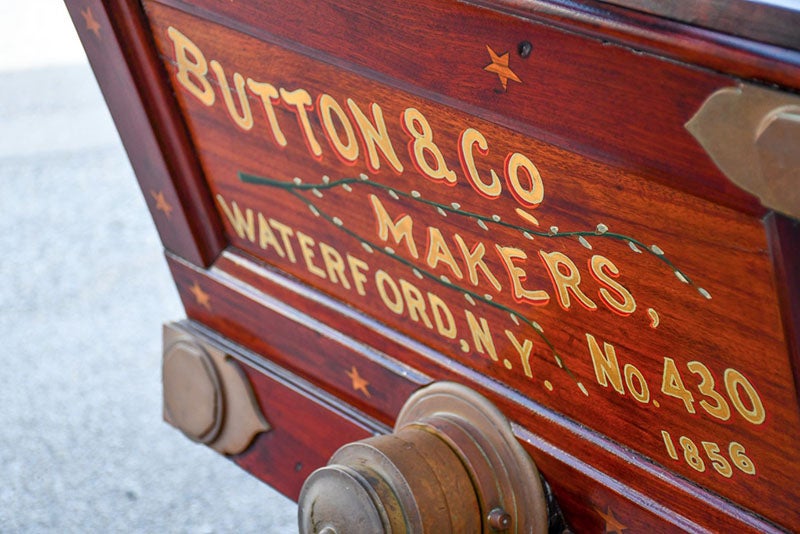 Close-up of the stern of the 1856 Button hand pumper shown just above, with the company logo (bringatrailer.com)