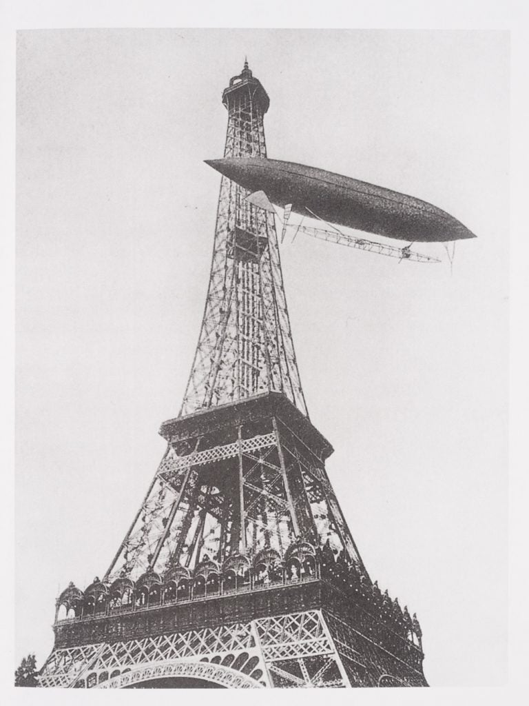 Santos-Dumont’s hydrogen-filled airship was 108 feet long and powered by a 12-horse-power engine connected to a two-blade propeller at the rear of the gondola. Hallion, Richard P. Taking Flight: Inventing the Aerial Age rom Antiquity Through the First World War. Oxford University Press, 2003. View Source.