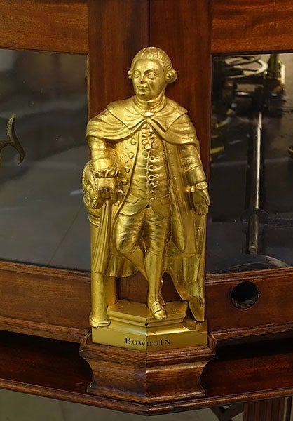 Statuette of James Bowdoin II, brass, possibly by Paul Revere, before 1787, one of four that adorn the base of the Joseph Pope orrery, Putnam Gallery, Harvard University (Wikimedia commons)
