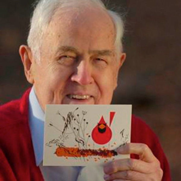 Photo portrait of Charley Harper, holding his well-known drawing of a cardinal and a corncob (charleyharperprints.com)