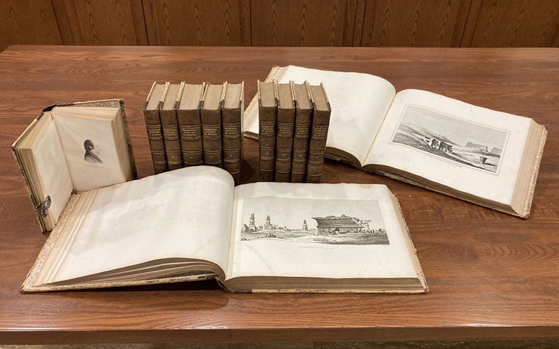 All 12 volumes of Histoire scientifique et militaire de l'expédition française en Egypte, by Louis Reybaud, 1830-36, including 10 octavo text vols, and two oblong quarto atlases; the opened text volume at left shows the portrait of André Detertre, who did all of the 160 portraits in the 10 volumes (Linda Hall Library copy)